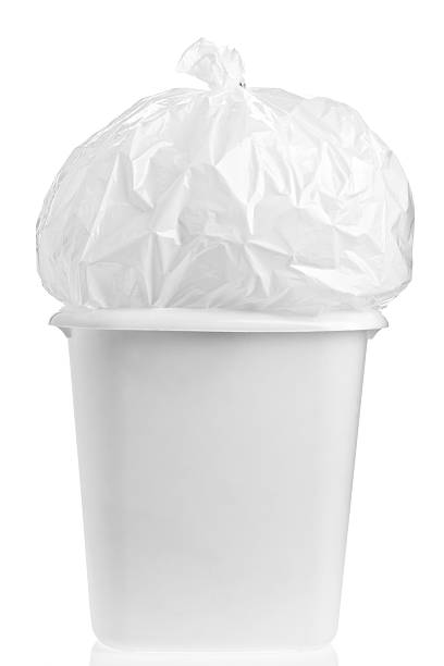 Overloaded garbage pail and plastic garbage bag on a white background.